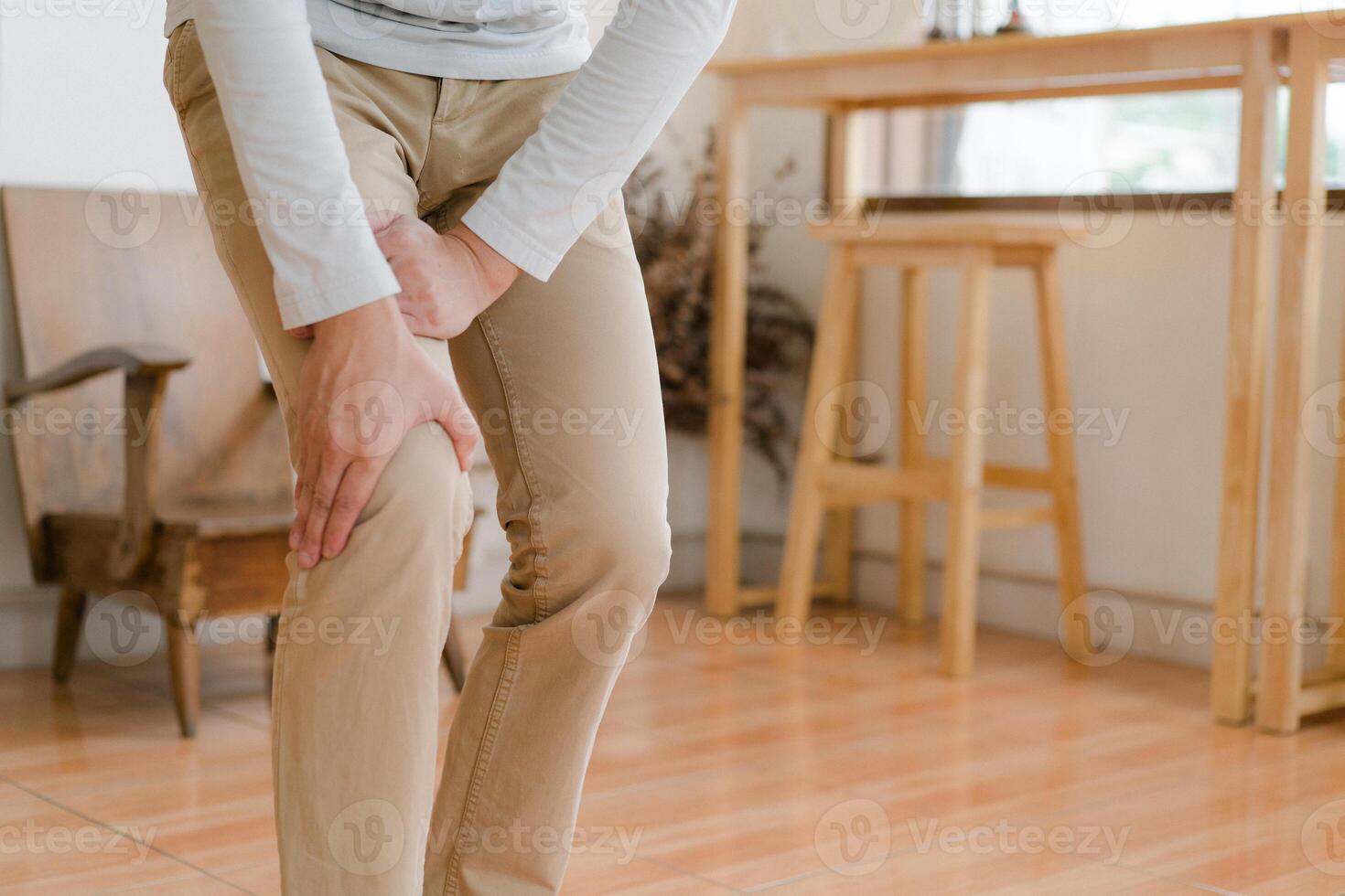 man suffering from pain in knee at home, closeup , healthcare concept photo