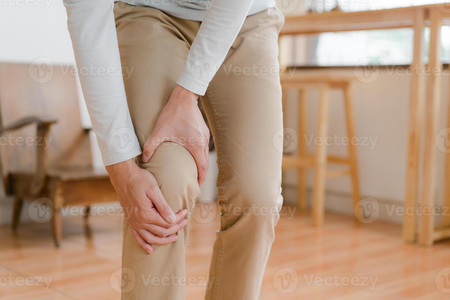 man suffering from pain in knee at home, closeup , healthcare concept photo