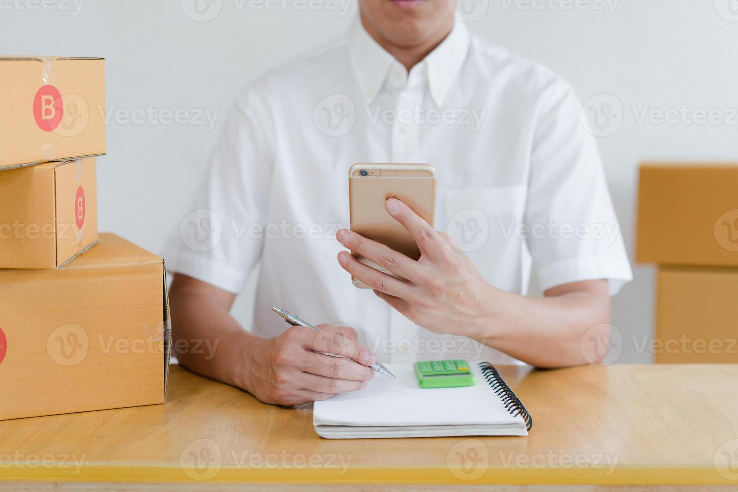 Portrait of Asian man packing box and check list in the office business , SME internet work from home business . photo