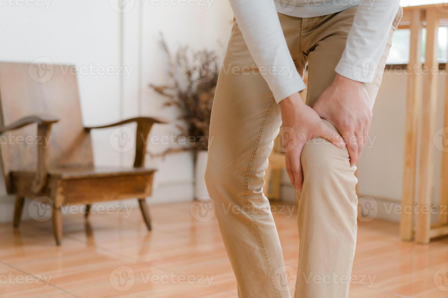 man suffering from pain in knee at home, closeup , healthcare concept photo