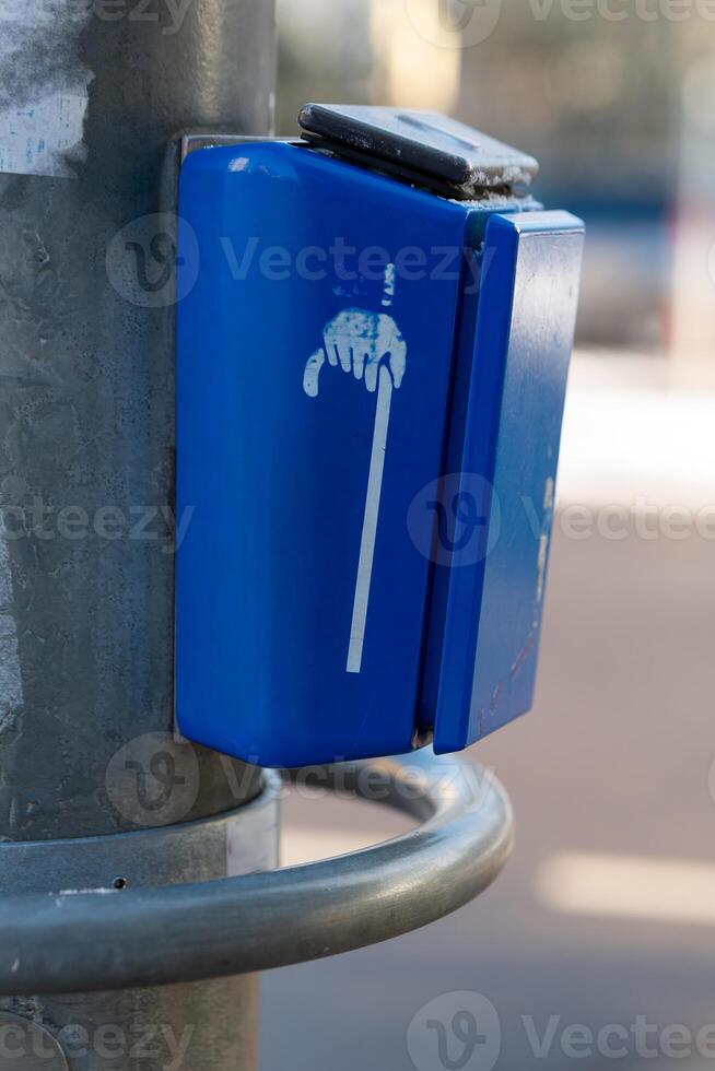 a button at a traffic light for people with walking disabilities photo