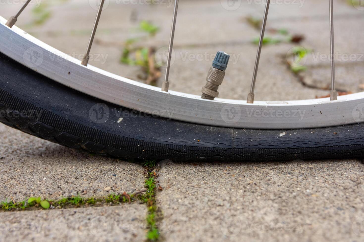 flat bicycle tire in selective focus photo