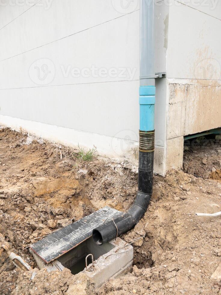 The temporary drain pipe from roof of the building to the concrete drain pipe. photo