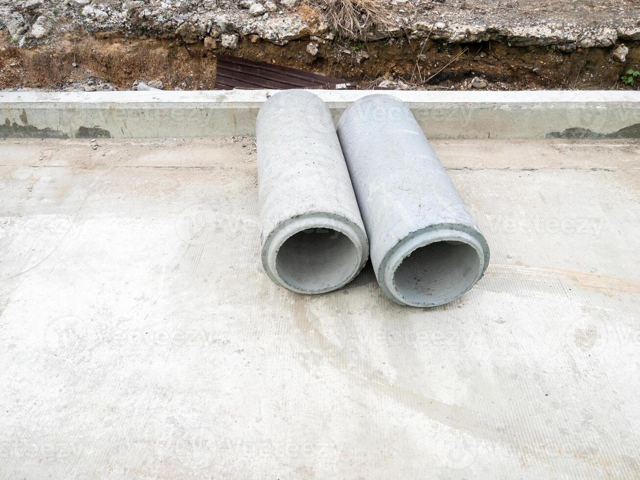 The new AC pipe asbestos cement pipes on the concrete road photo