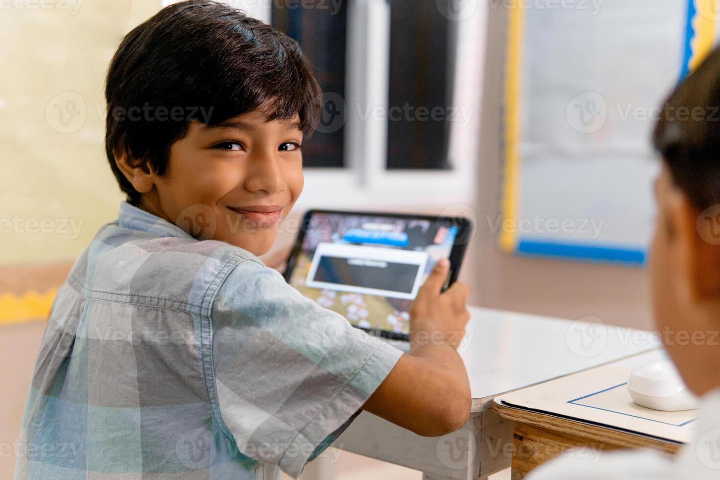 Portrait of Elementary Hispanic school Kids using tablet computers in class photo