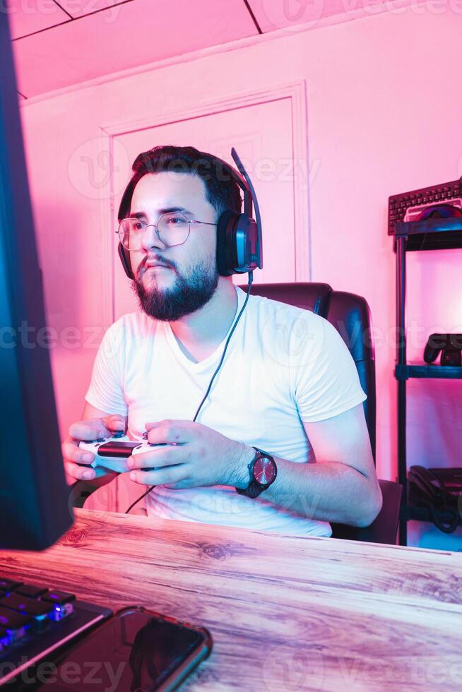 Professional video game player holding a joystick playing with a console. photo