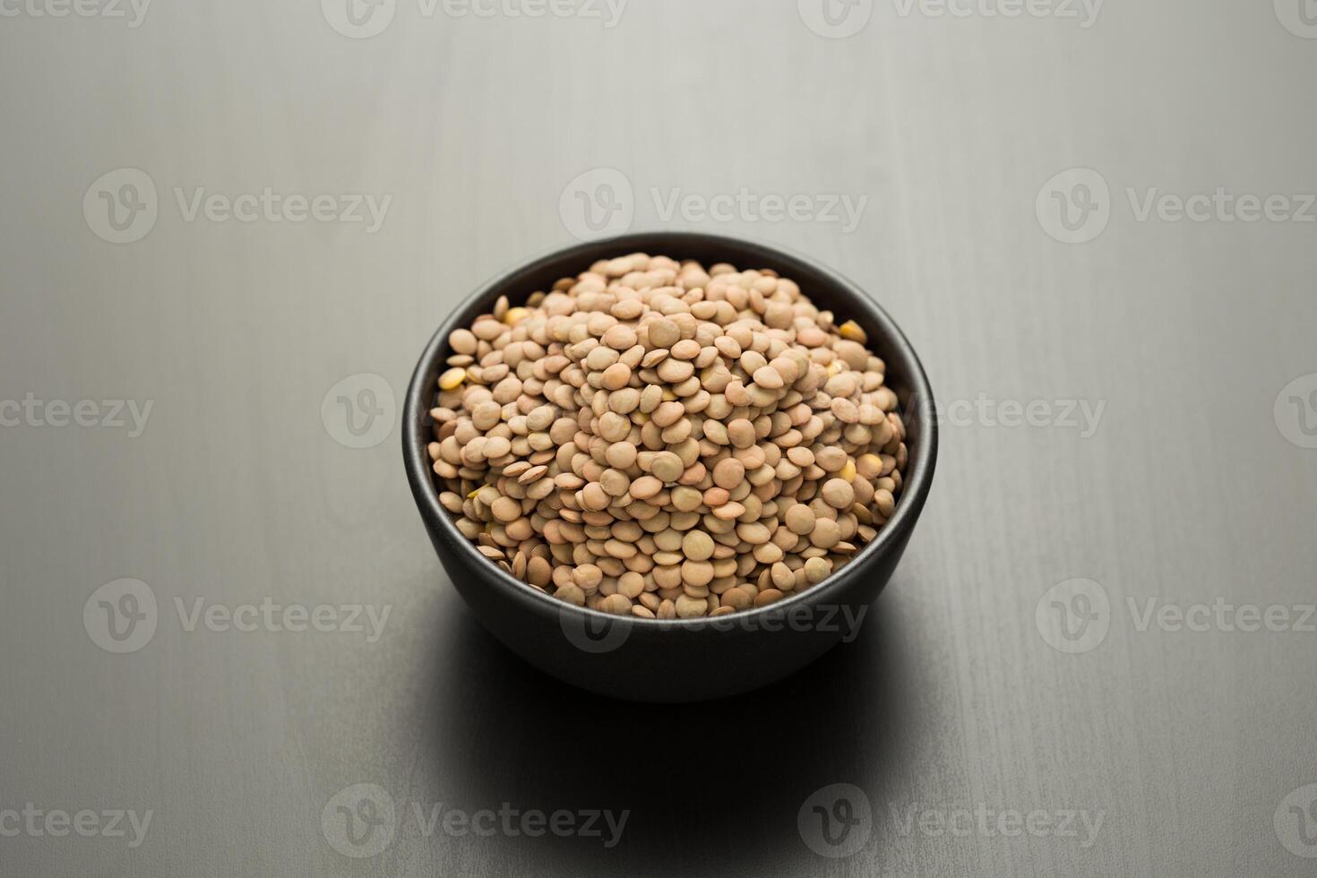 Brown lentils in a bowl. photo
