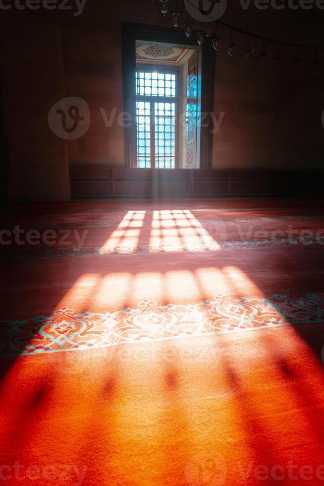 Islamic concept. Sunlight coming through from the window of a mosque with haze. photo