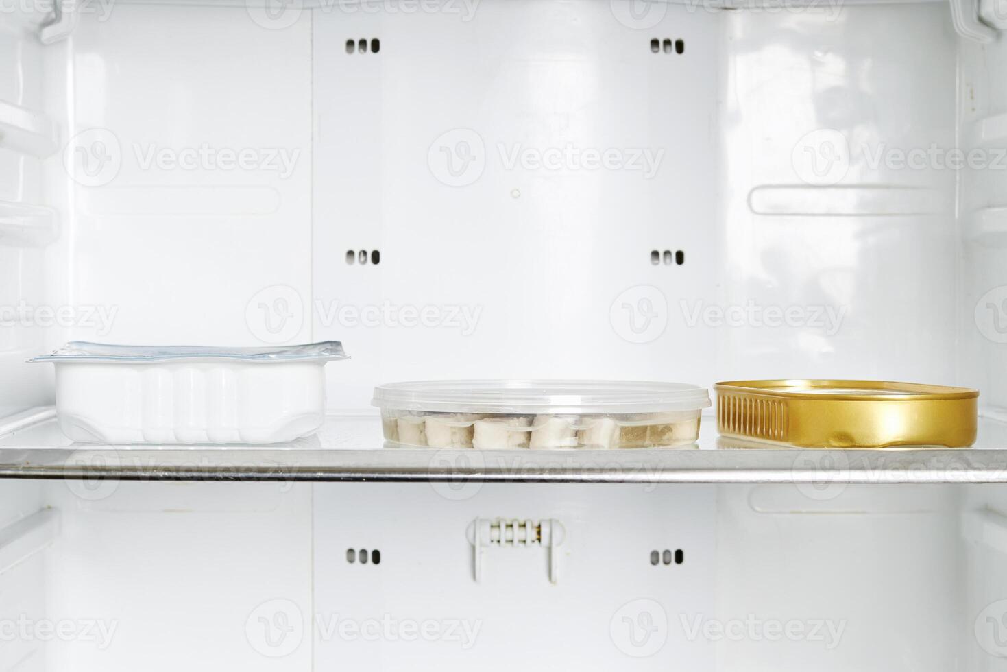 a refrigerator with a gold container inside photo
