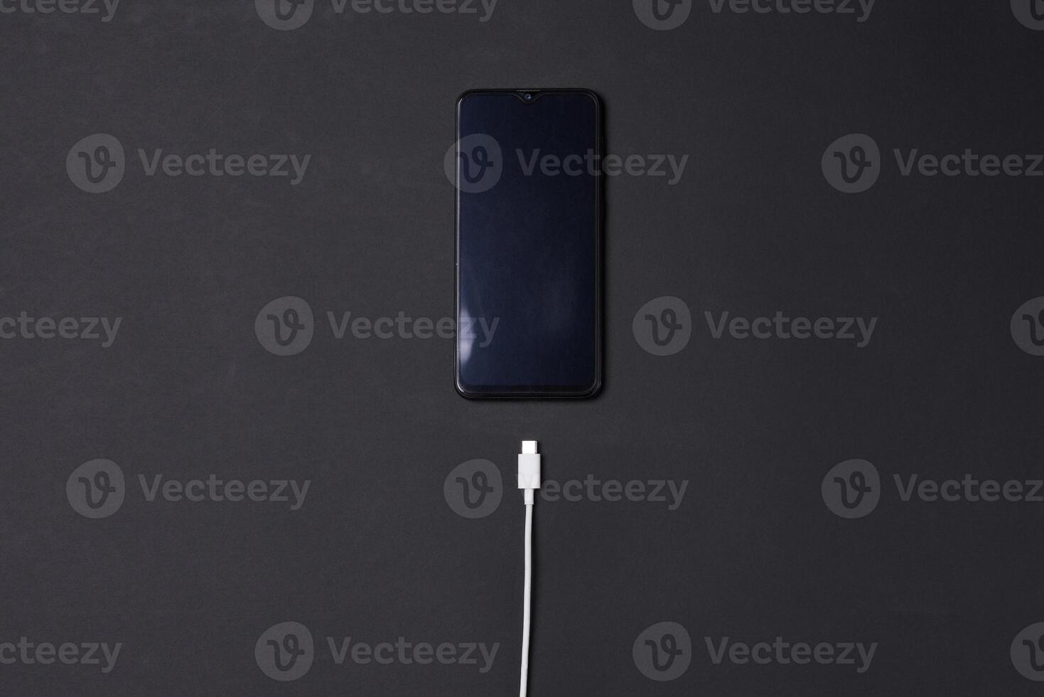 a smartphone is connected to a power source and a wall outlet photo