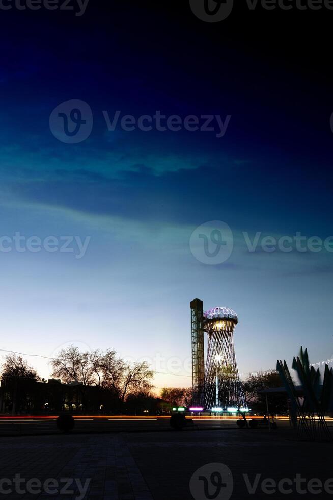 Lit up water tower photo