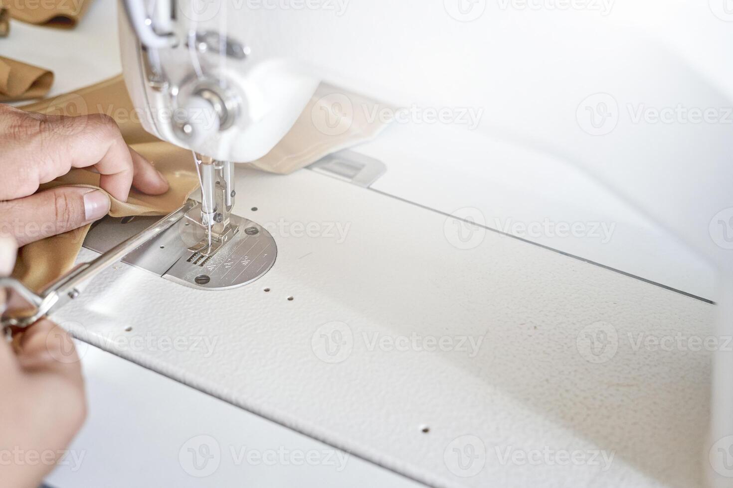 a person is using a sewing machine to make a piece of clothing photo