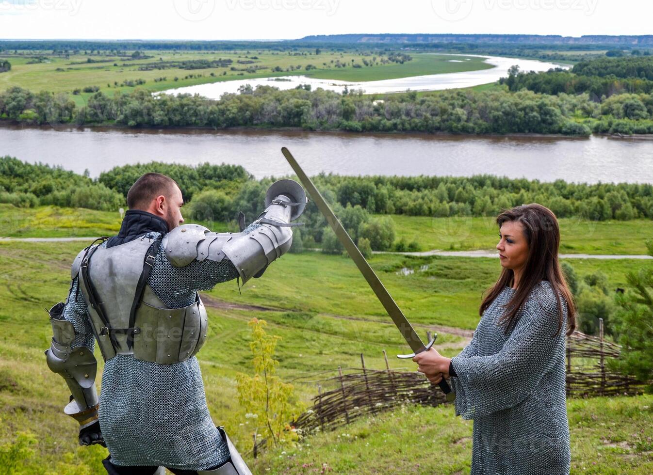 A lady in chain mail and a knight in armor photo