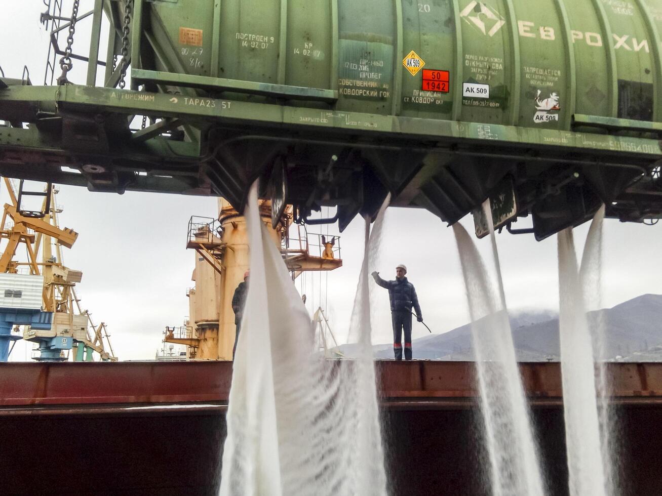 Russia, Novorossiysk 2021.  spillage of saltpeter from the car into the hold of the tanker. Loading of mineral fertilizers in the ship's hold. photo