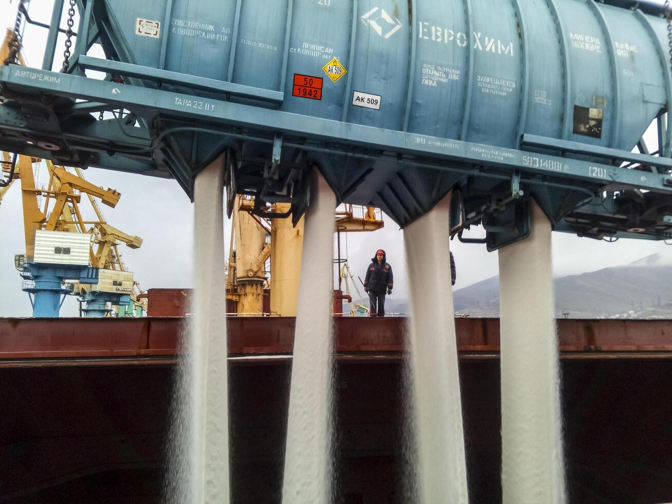 Russia, Novorossiysk 2021.  spillage of saltpeter from the car into the hold of the tanker. Loading of mineral fertilizers in the ship's hold. photo