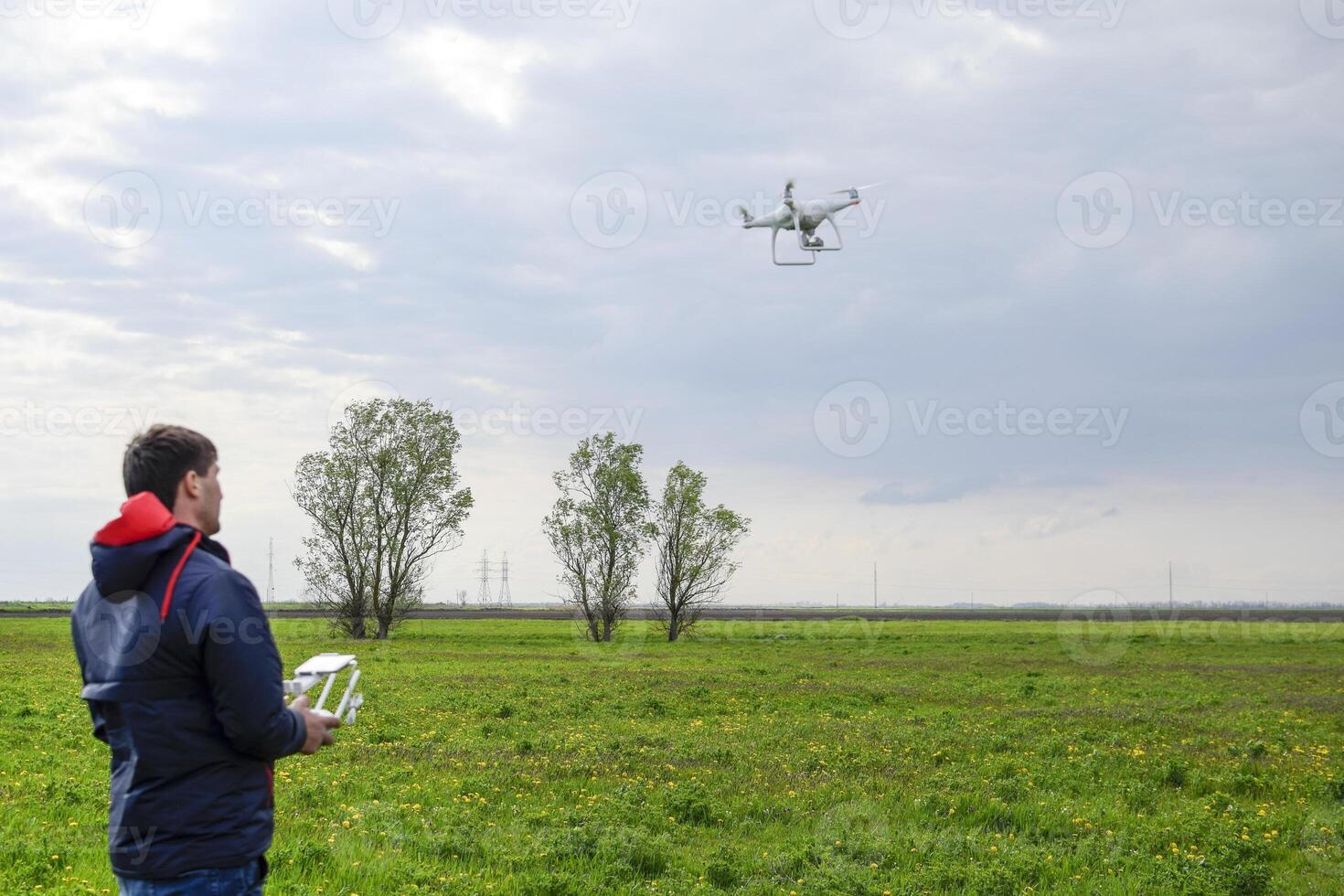 A man with a remote control in his hands. Flight control of the photo