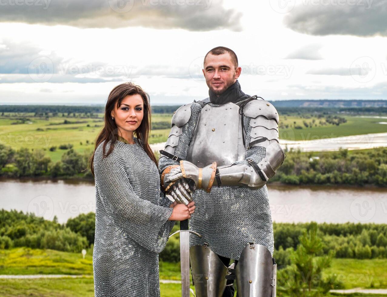 Knight with his lady in armor and chain mail. photo