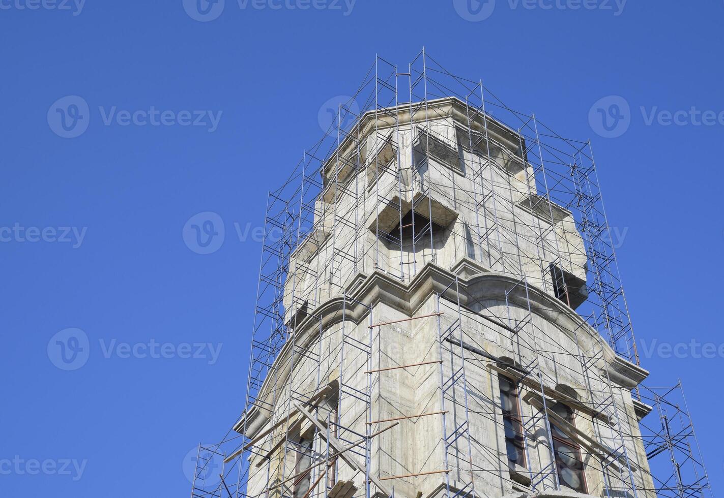 Construction of an Orthodox chapel. Scaffolds along the walls of the building photo