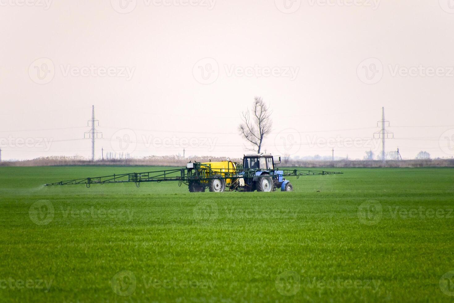 Tractor making fertilizer by spray photo