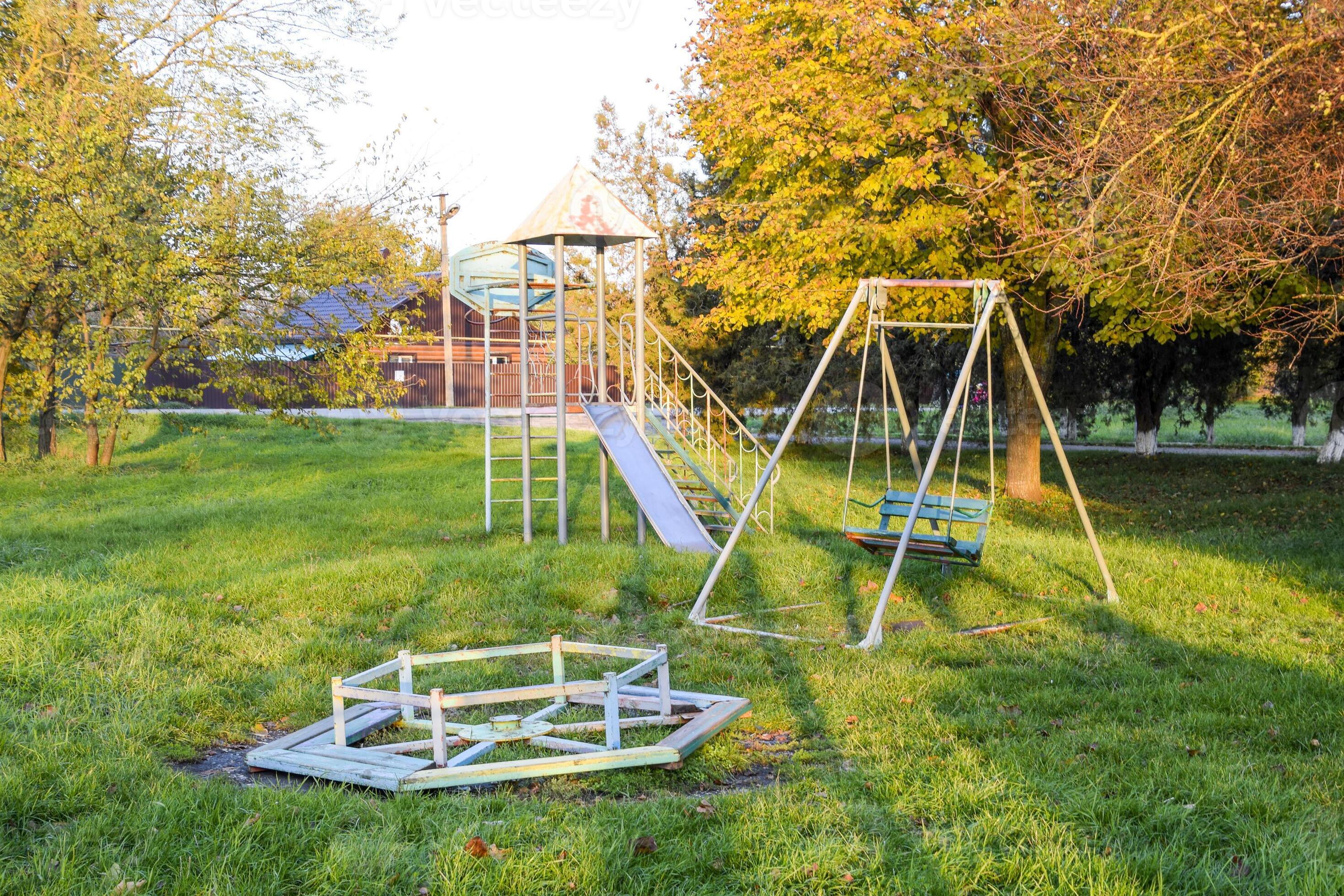 Carousel, swing and slide. Children playground. Swings and a slide to