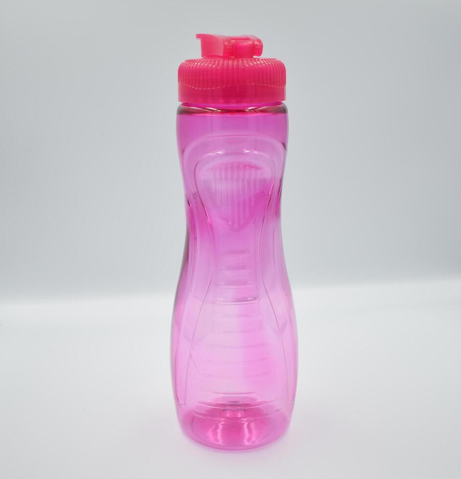 a pink water bottle with a lid on a white surface photo