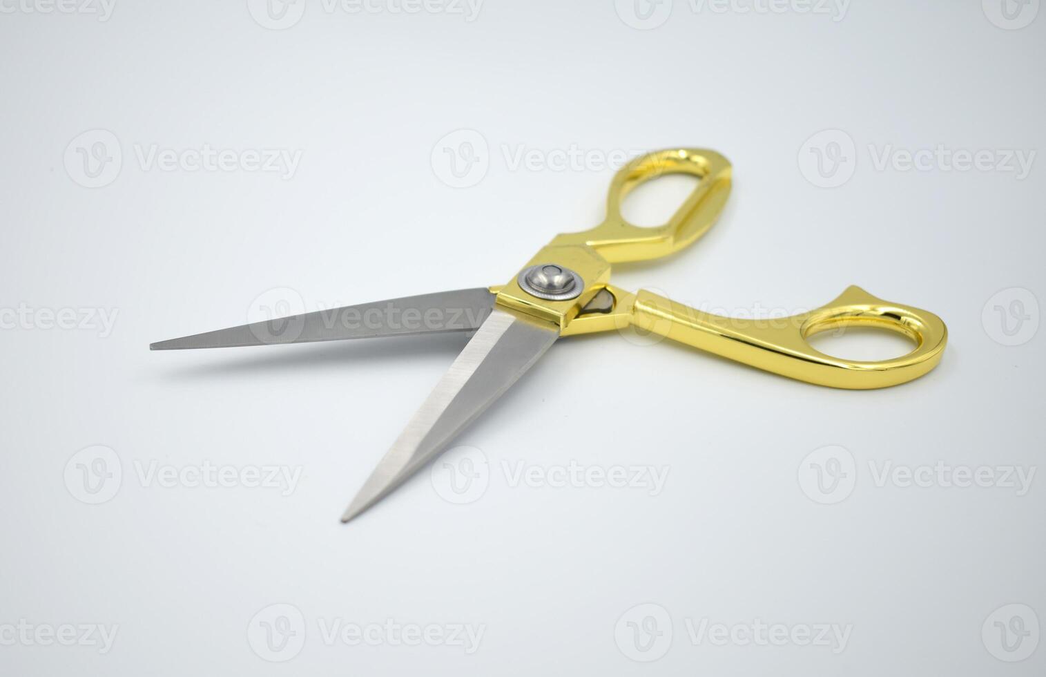 Silver and gold metal cloth scissors on white background photo