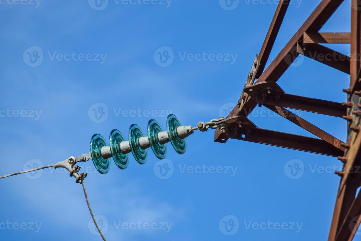 Glass prefabricated high voltage insulators on poles high-voltage power lines. Electrical industry photo