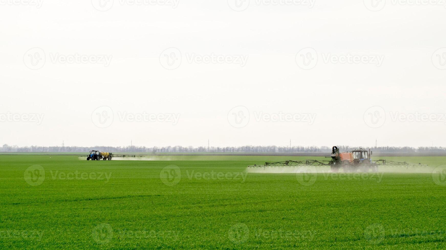 Tractor with a spray device for finely dispersed fertilizer. photo