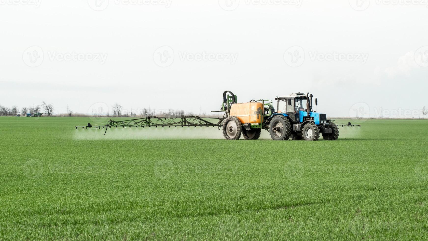 Tractor with a spray device for finely dispersed fertilizer. photo