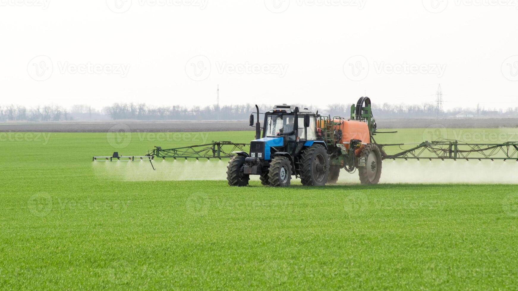 Tractor with a spray device for finely dispersed fertilizer. photo