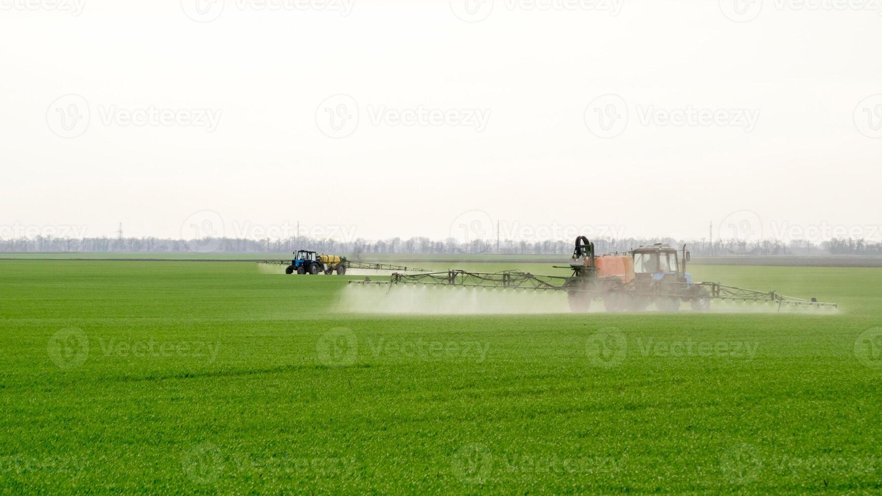 Tractor with a spray device for finely dispersed fertilizer. photo