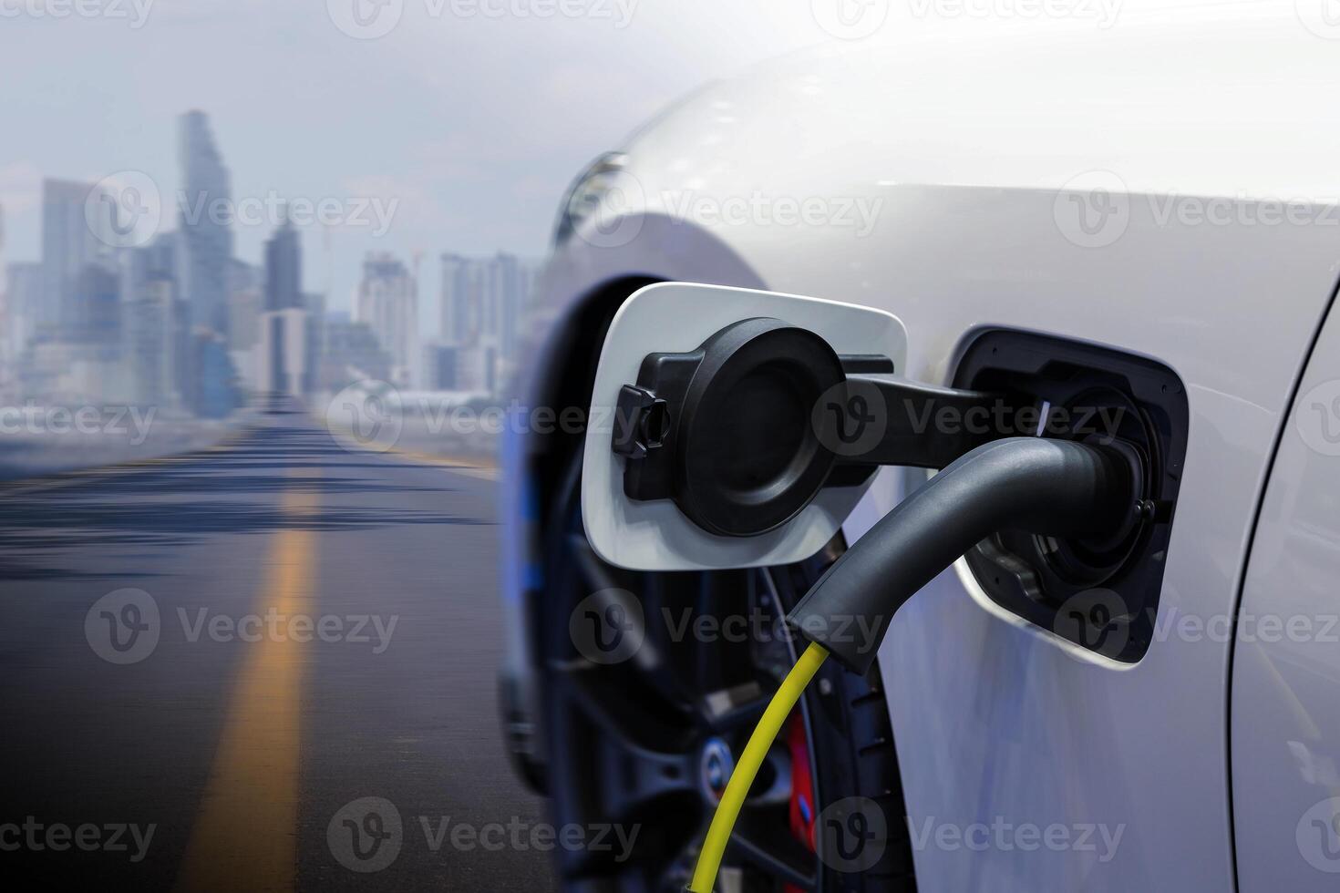 Power cable pump plug in charging power to electric vehicle EV car. photo