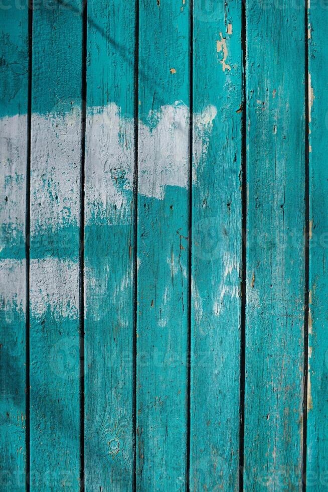 Vintage wood background with peeling paint. Traces of knots and old nails photo