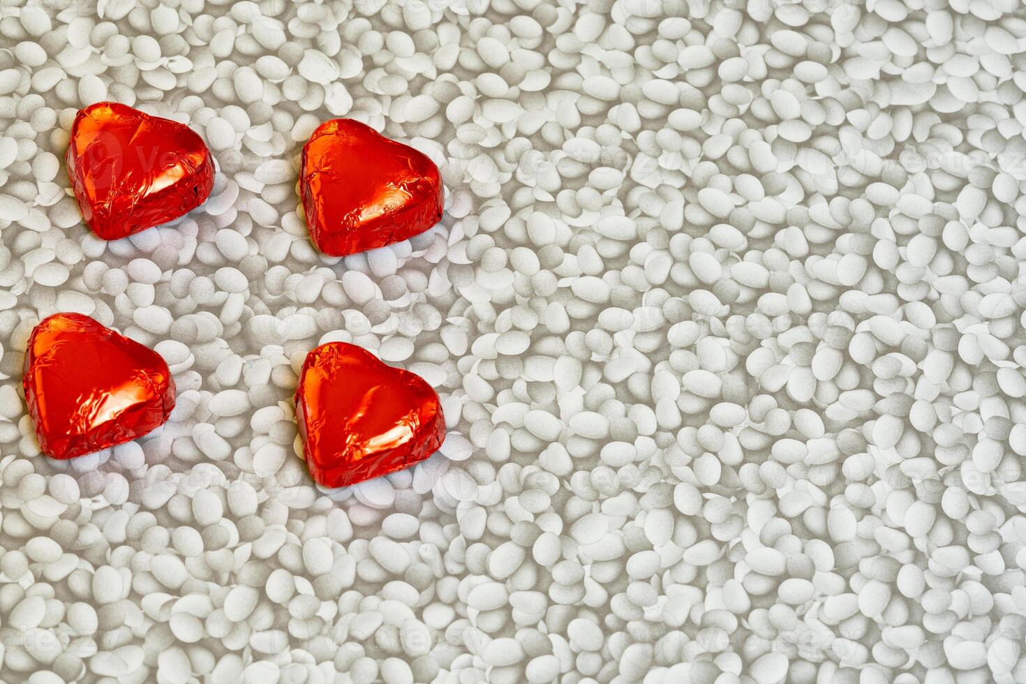 valentines day four chocolates on a white pattern background photo