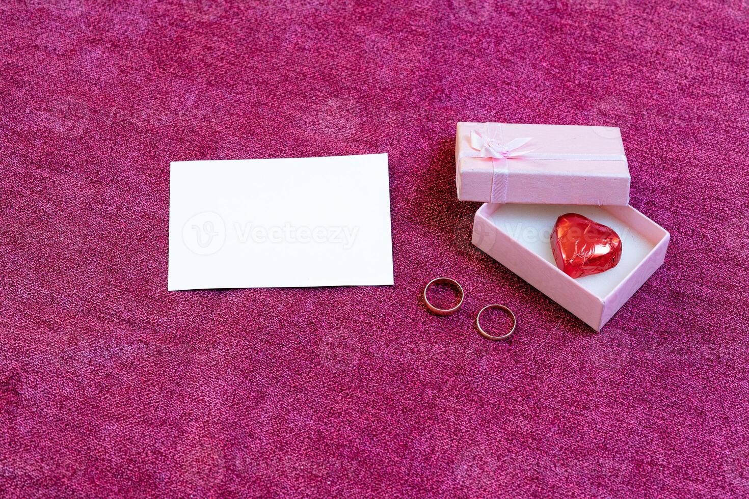 valentines day card heart shaped chocolate and rings photo