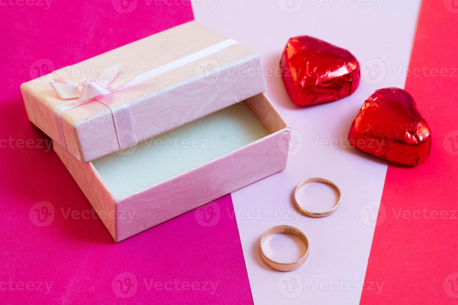 valentines day engagement rings and two heart shaped chocolates photo
