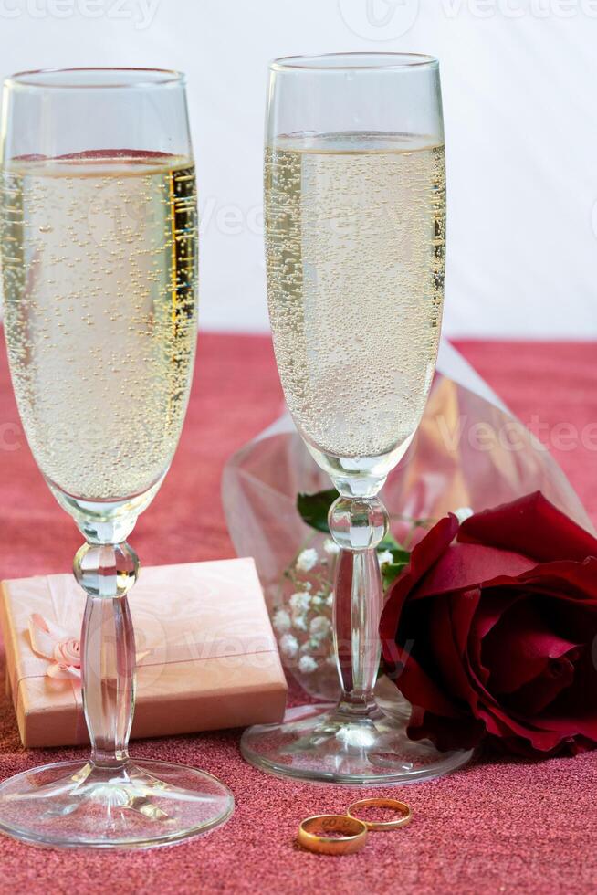 valentines day glasses of champagne flowers and engagement rings photo