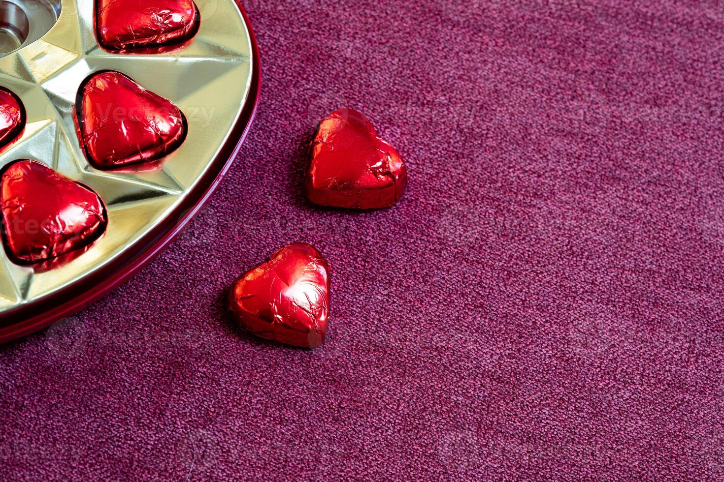 heart shaped chocolates out of a chocolate box with copy space photo