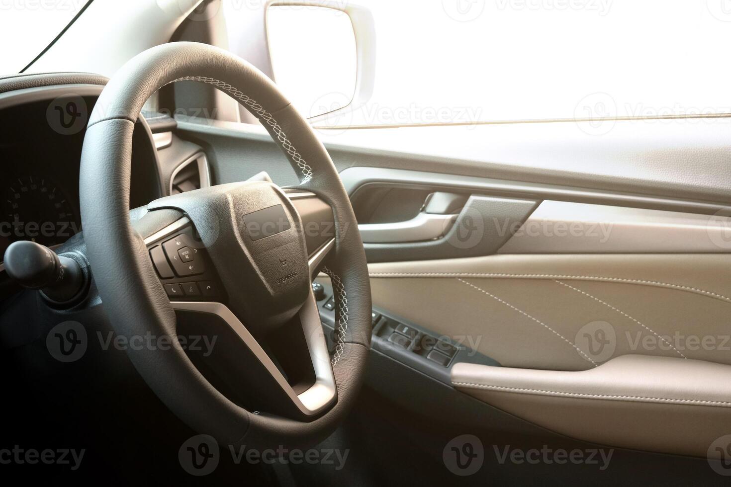 Car steering wheel. Interior element of a modern car. Controlling the direction of the car and the concept of careful driving. photo