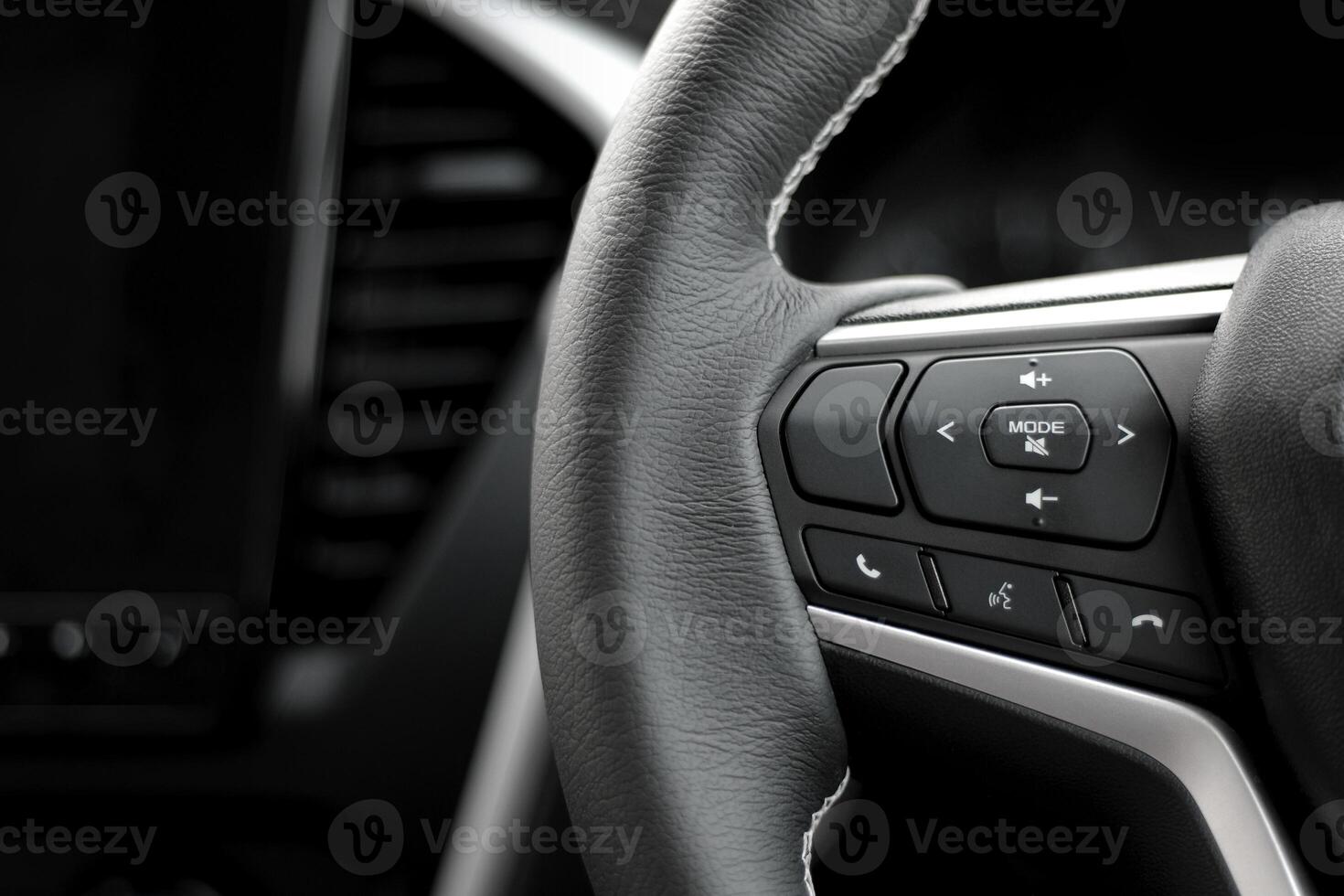 Control switch on the steering wheel. Settings and sound adjustment buttons.  close-up view photo