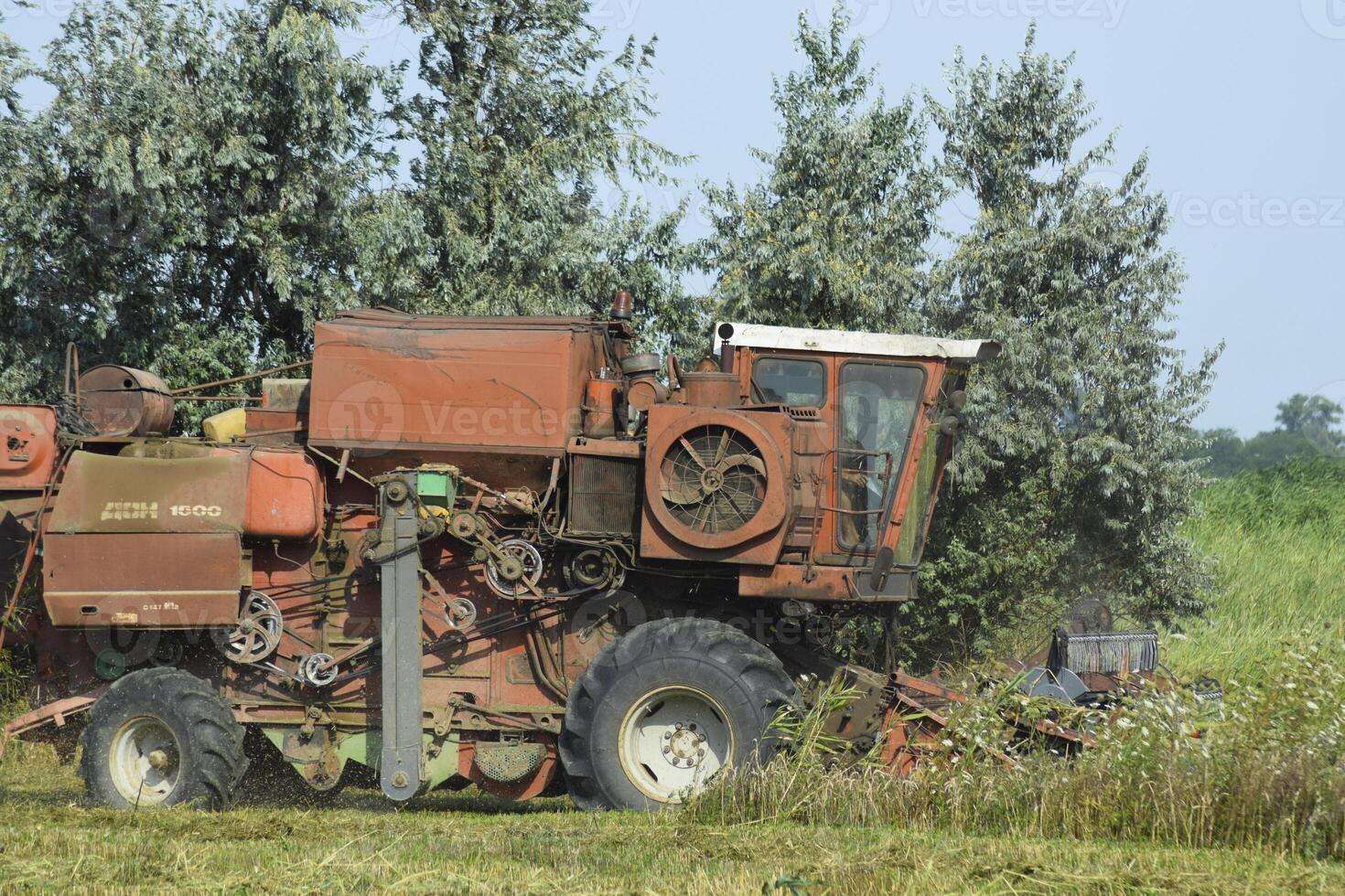 Old rusty combine harvester. photo