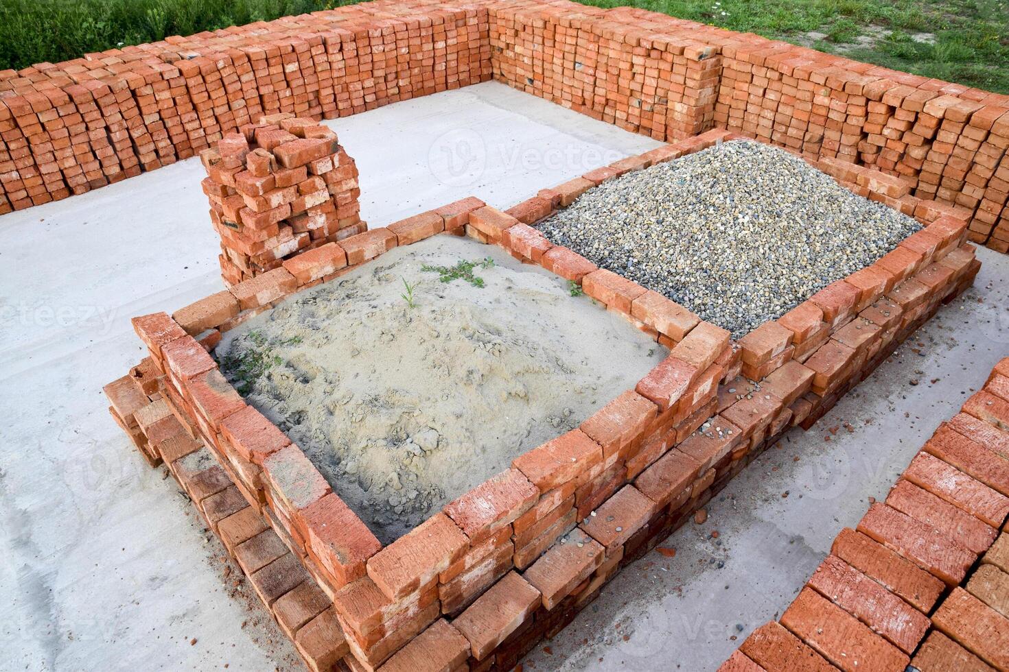 The red brick folded neatly on the foundation of the house. Home construction photo