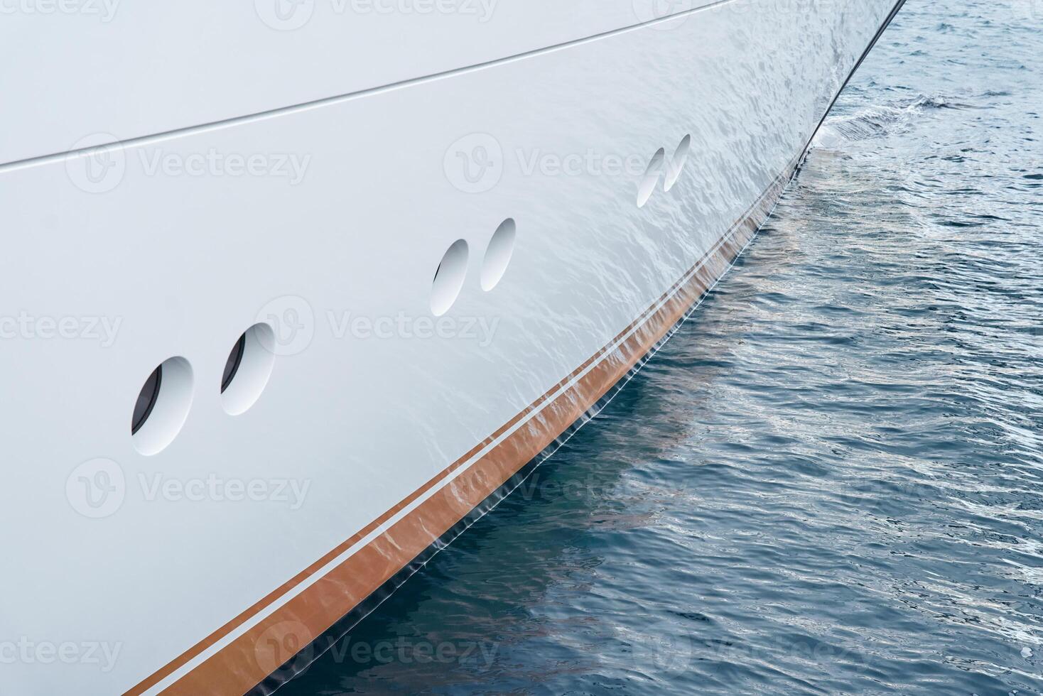 Sun glare on glossy board of mega yacht, anchor, tranquillity in port Hercules, bow of moored huge boat at sunny day, Monaco, Monte-Carlo photo