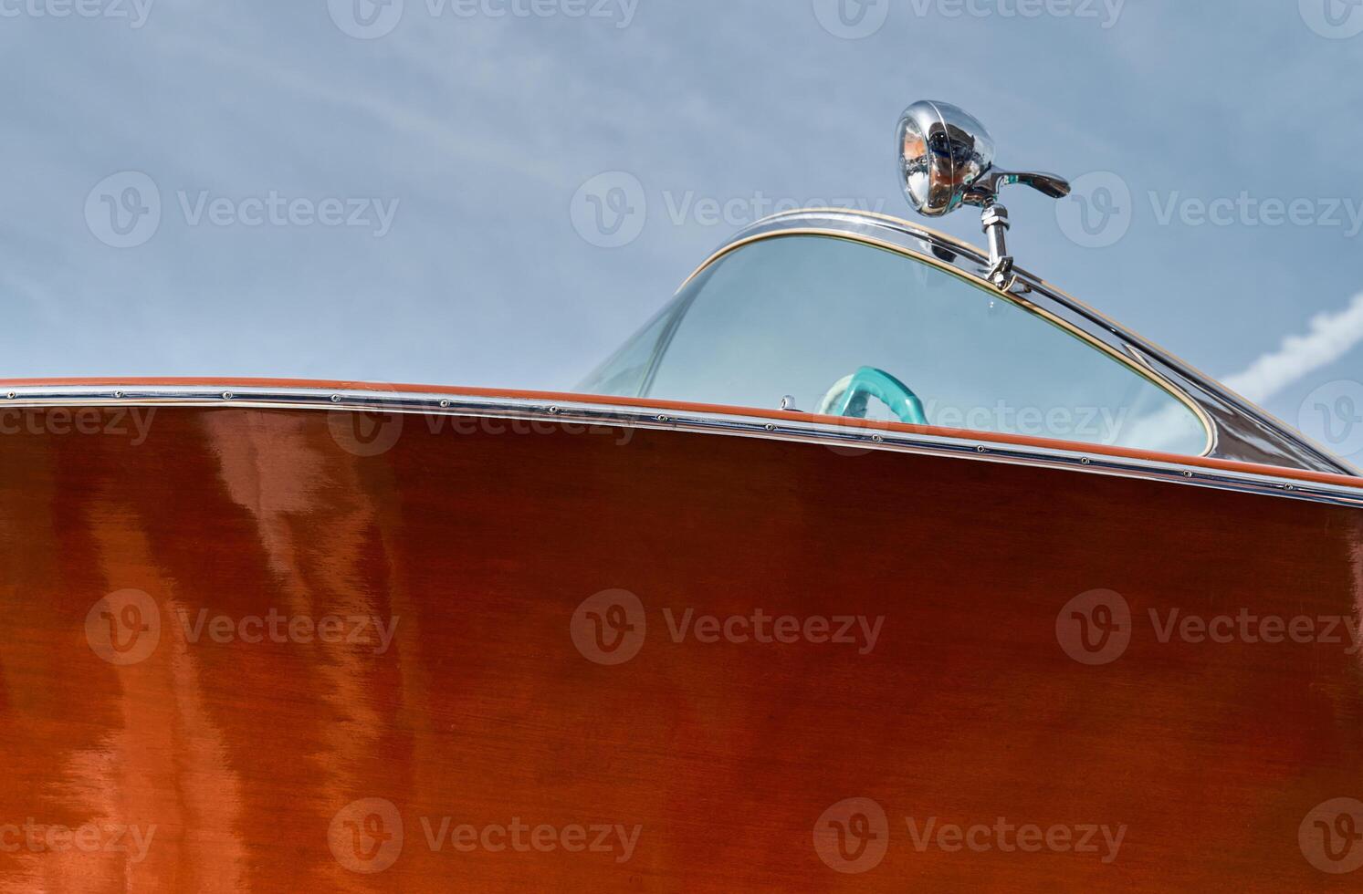 the wooden side of the luxury motor boat in port of Hercules in Monaco, sunny glare of the sun, elegance boat, glossy surfaces shine in sunny weather photo