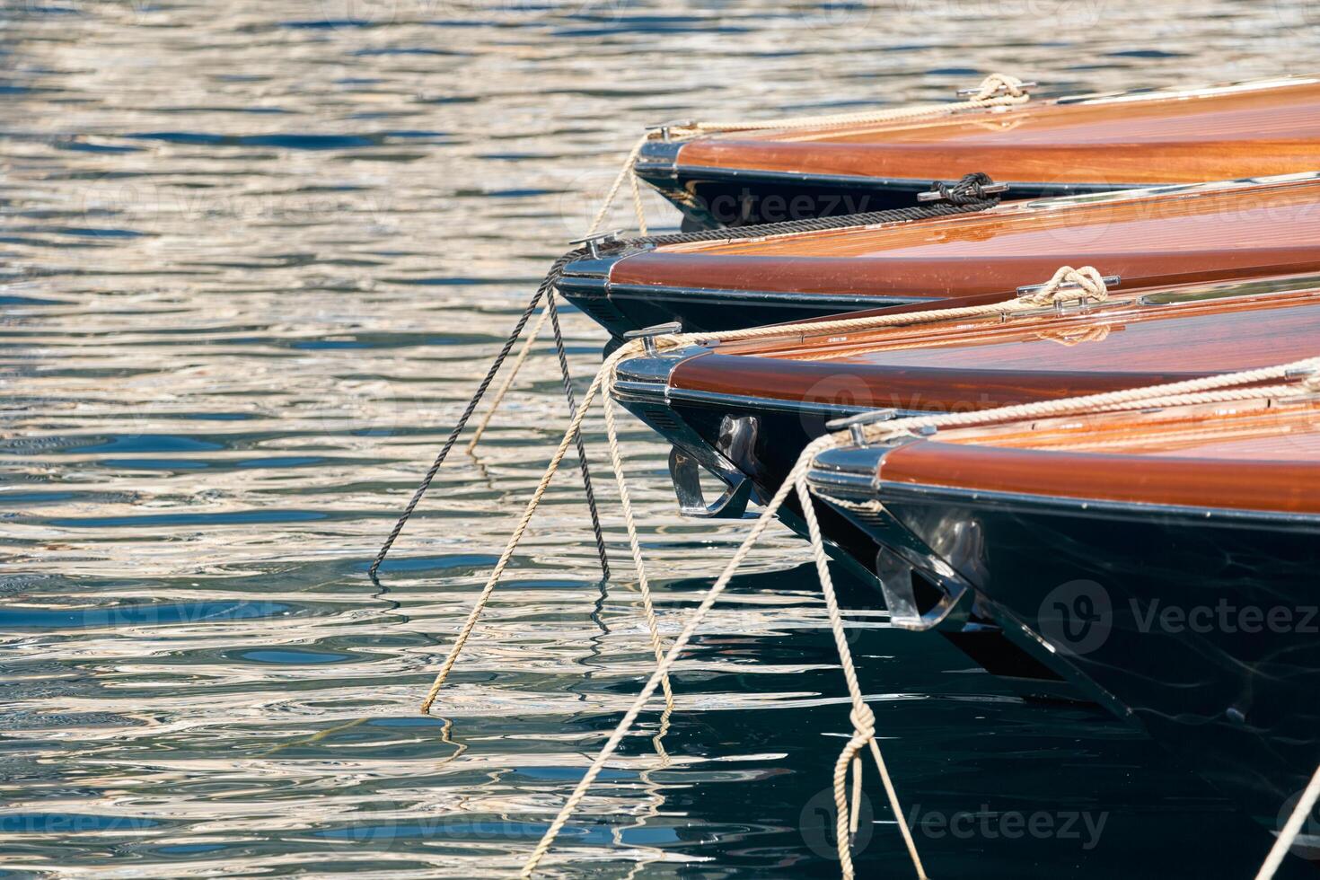 Few luxury retro motor boats in row at the famous motorboat exhibition in the principality of Monaco, Monte Carlo, the most expensive boats for the richest people, boats for rich clients photo