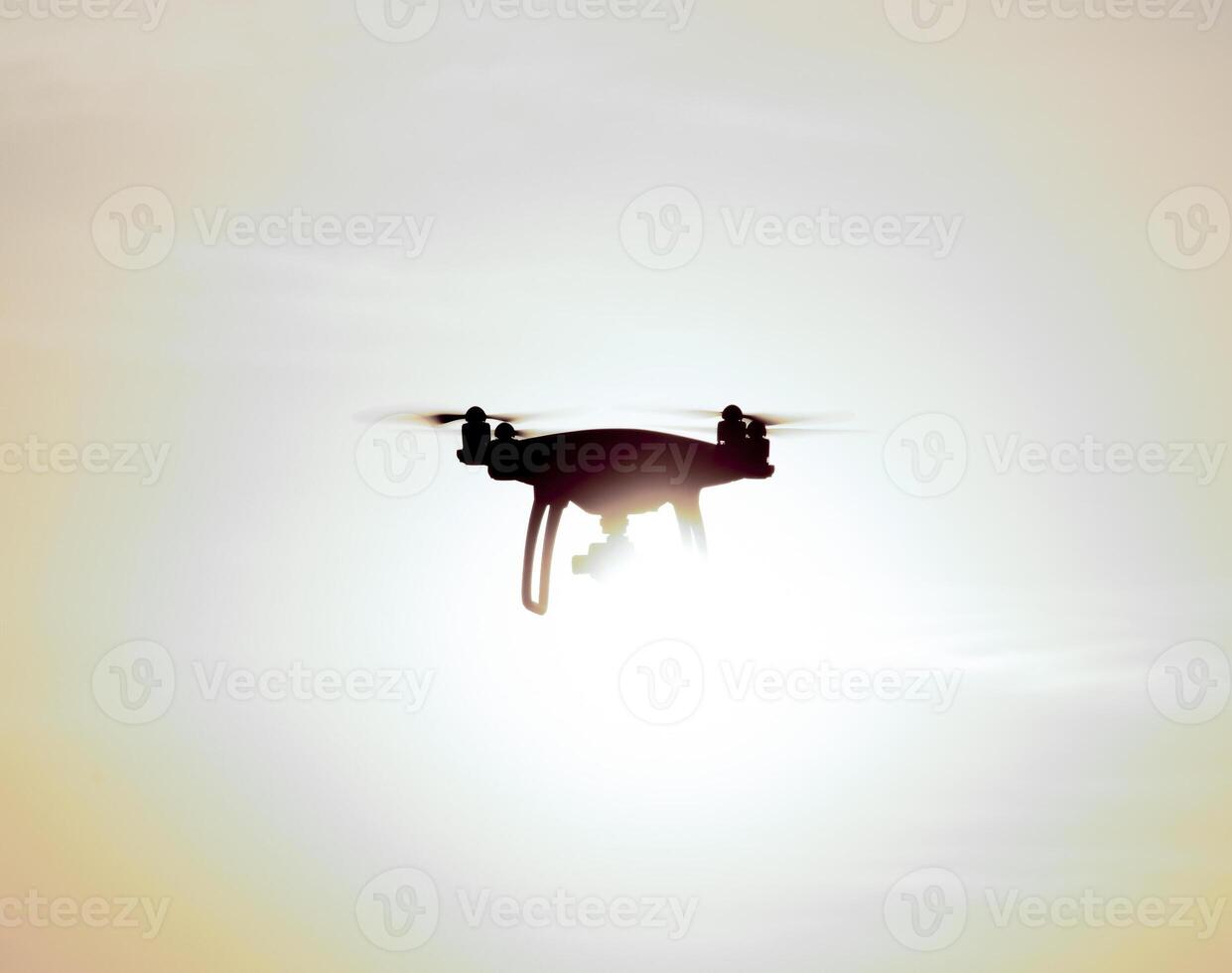 Quadrocopters silhouette against the background of the sunset photo