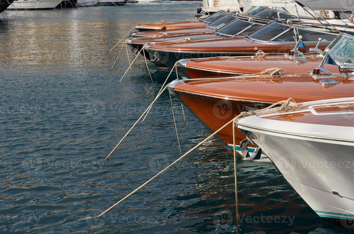 Few luxury retro motor boats in row at the famous motorboat exhibition in the principality of Monaco, Monte Carlo, the most expensive boats for the richest people, boats for rich clients photo