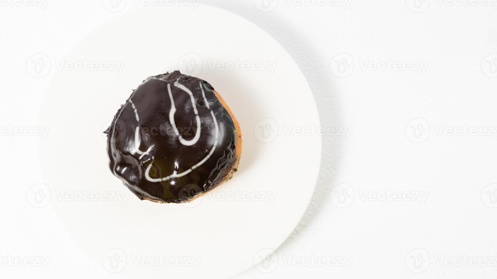 photo of donuts isolated in white background. Donuts with chocolate cream on top