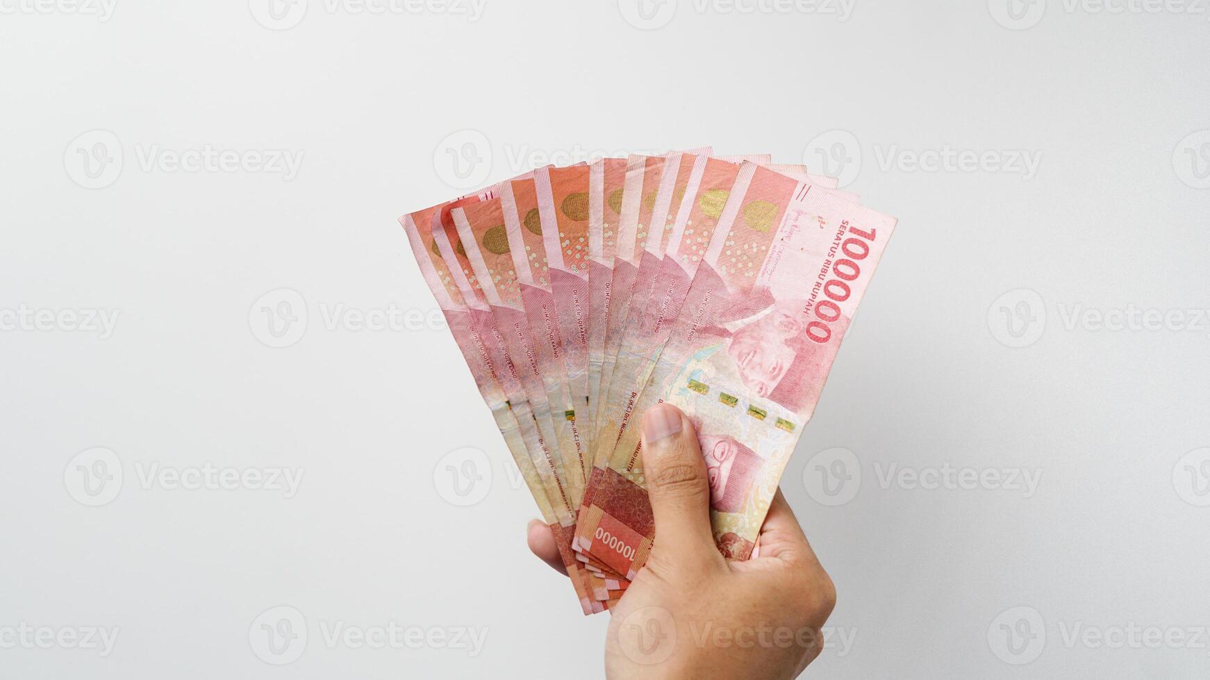 Hand holding Indonesian rupiah money. Indonesian currency photo