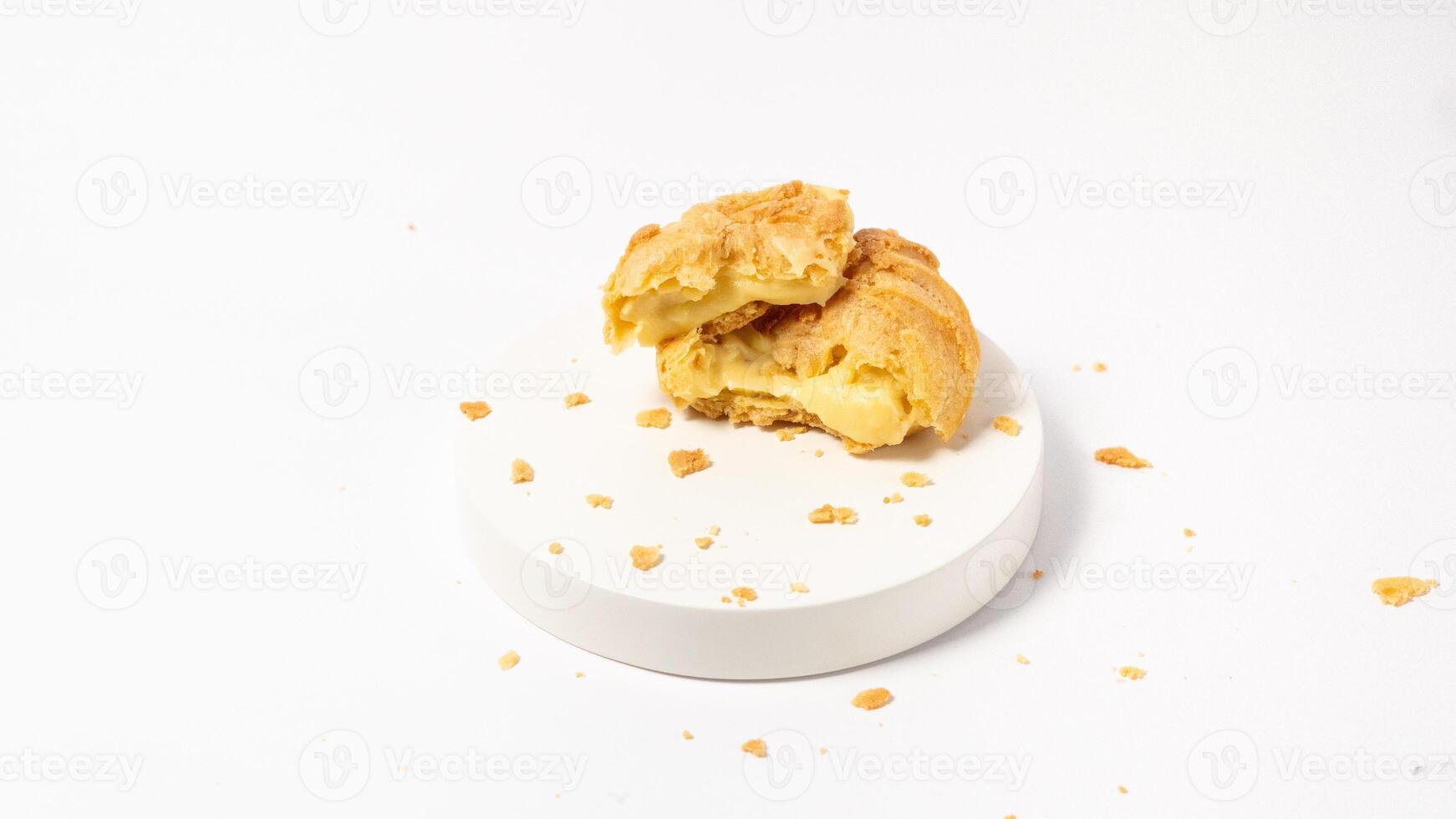 Freshly baked cream puffs or Vanilla eclairs isolated on white background photo
